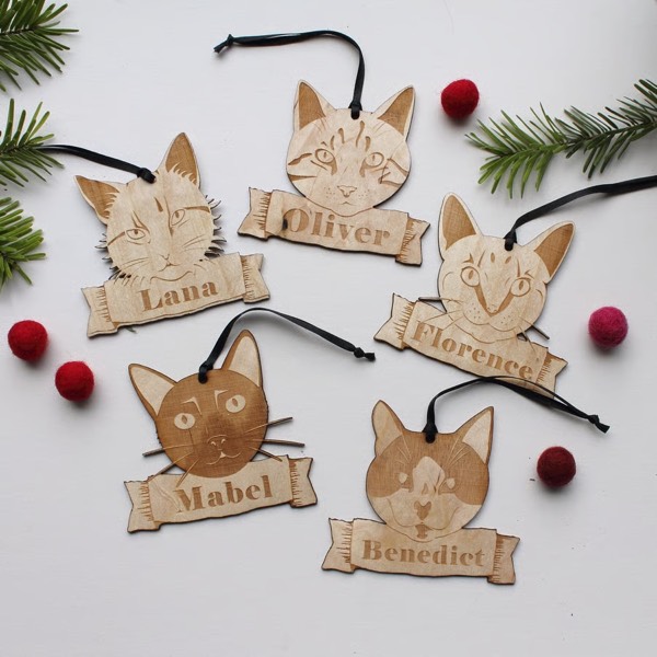 Laser-cut wooden cat ornaments featuring original artwork